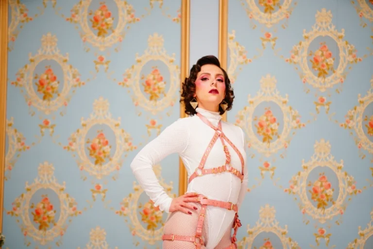 Mistress obelia dressed in white, standing.