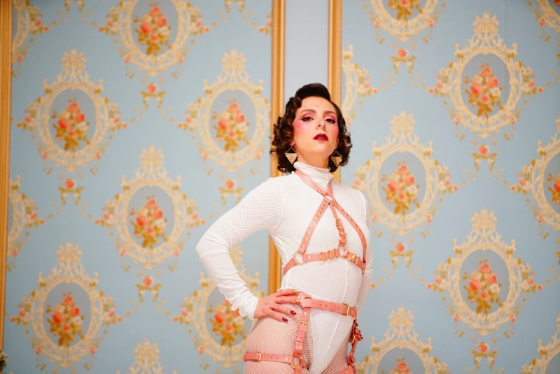 Mistress obelia dressed in white, standing.